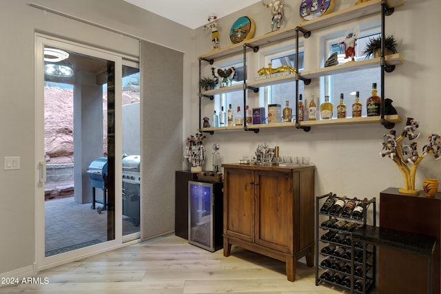 bar with light hardwood / wood-style flooring