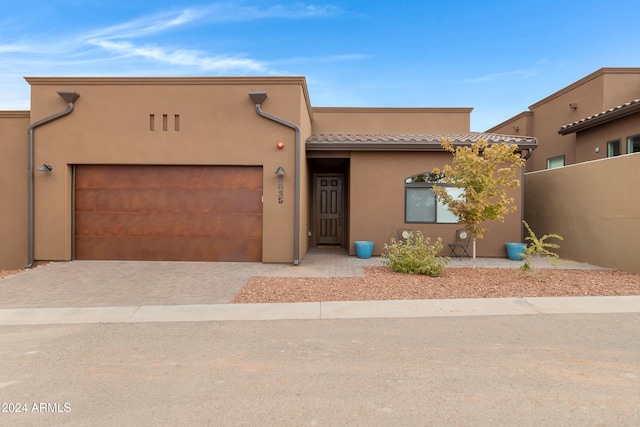 southwest-style home featuring a garage