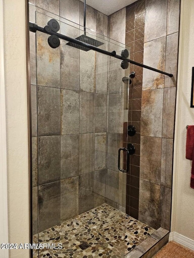 bathroom with a shower with door