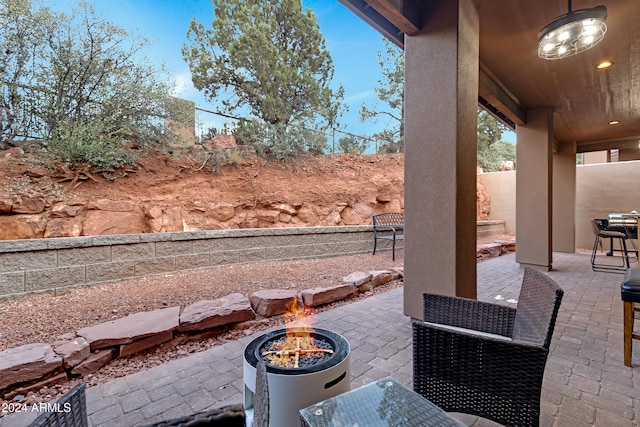 view of patio with an outdoor fire pit