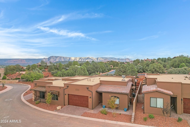 view of front of home featuring a mountain view and a garage