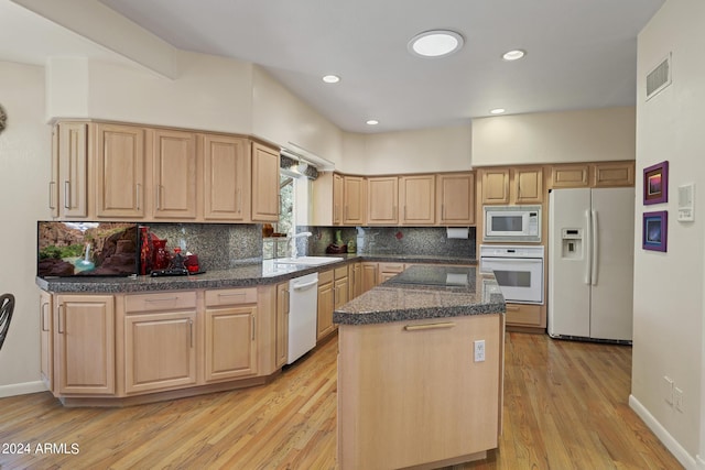 kitchen featuring light brown cabinetry, light wood-type flooring, a kitchen island, white appliances, and decorative backsplash