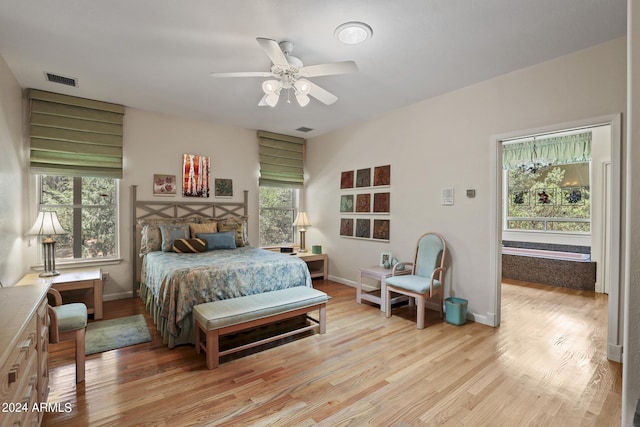 bedroom with ceiling fan and light hardwood / wood-style floors