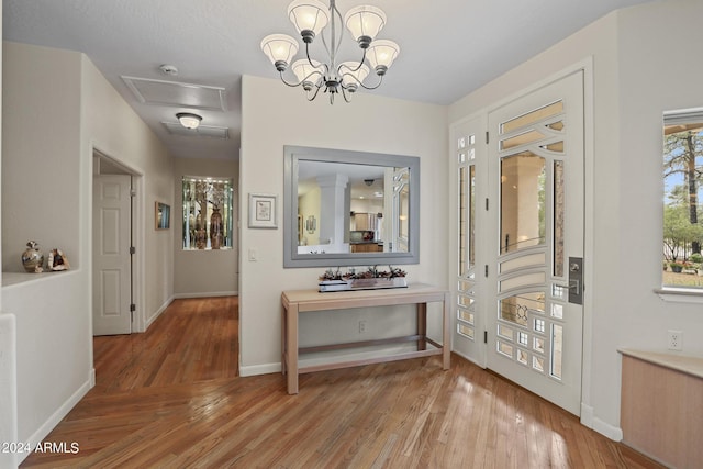 hall with hardwood / wood-style flooring and a chandelier