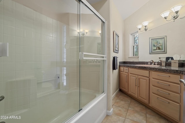 bathroom with enclosed tub / shower combo, vanity, and tile patterned floors