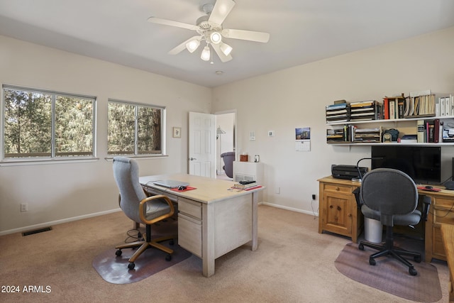 carpeted home office with ceiling fan