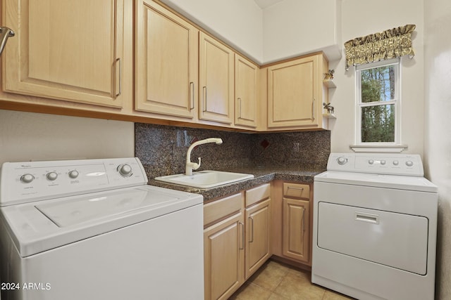 laundry area with washer and dryer, sink, cabinets, and light tile patterned flooring