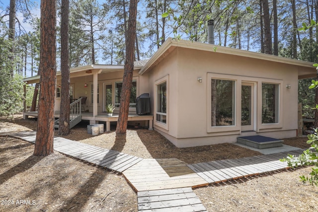 rear view of property featuring a deck