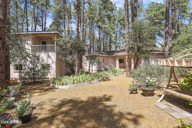 rear view of property with a balcony