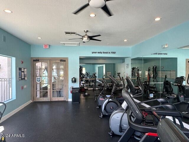 exercise room with french doors, a textured ceiling, and ceiling fan