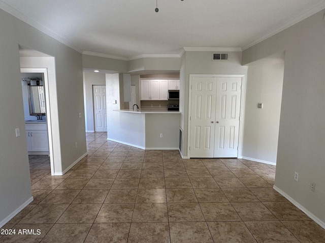 tiled spare room with crown molding