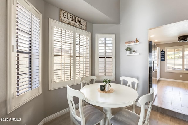 dining room with baseboards and wood finished floors