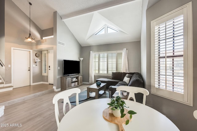 dining room featuring stairway, wood finished floors, visible vents, and baseboards