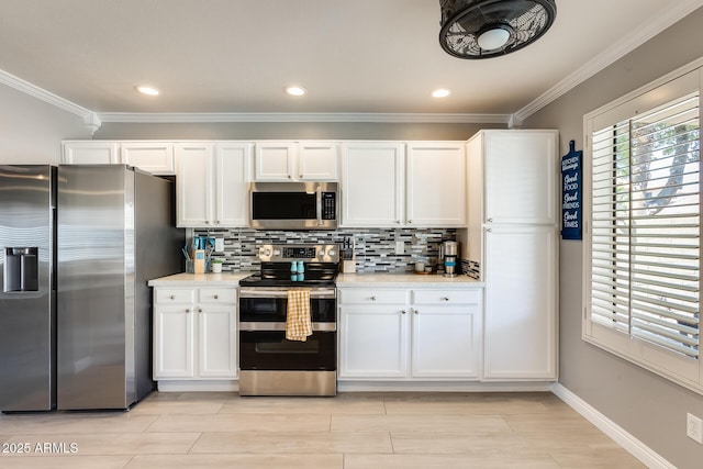 kitchen with light countertops, appliances with stainless steel finishes, white cabinetry, and tasteful backsplash