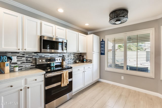 kitchen featuring appliances with stainless steel finishes, white cabinetry, and tasteful backsplash