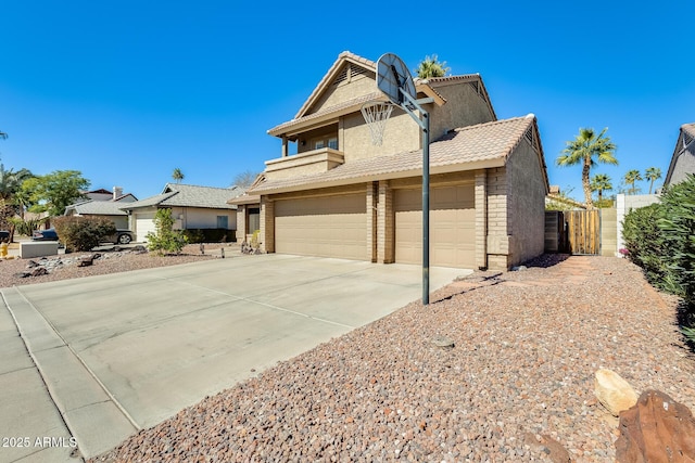 traditional home featuring stone siding, concrete driveway, and a tile roof