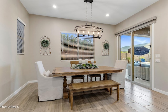 dining room featuring recessed lighting, baseboards, a notable chandelier, and a wealth of natural light