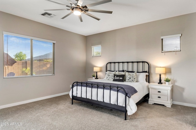 bedroom featuring baseboards, ceiling fan, light colored carpet, and visible vents