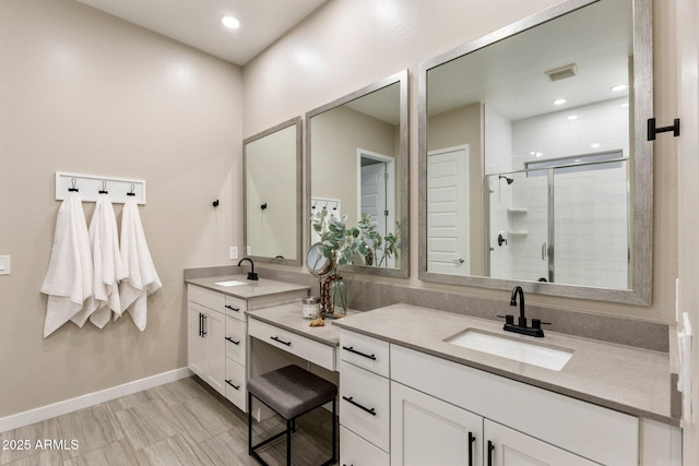 bathroom featuring visible vents, a stall shower, vanity, baseboards, and recessed lighting