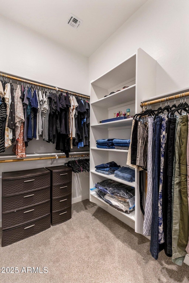 walk in closet featuring visible vents and carpet flooring