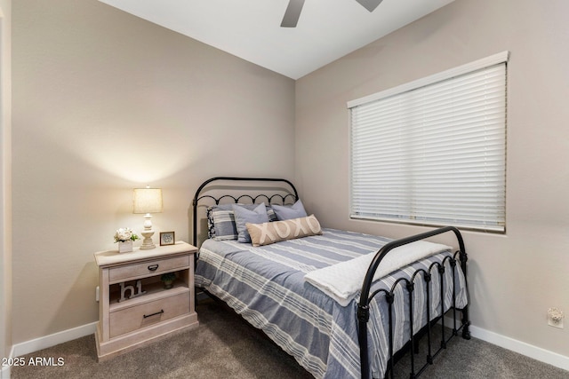 bedroom featuring baseboards, dark colored carpet, and lofted ceiling