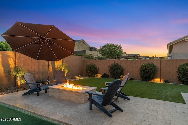 view of patio with a fenced backyard and a fire pit