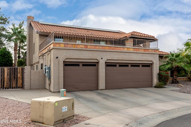 view of front of home with a balcony and a garage