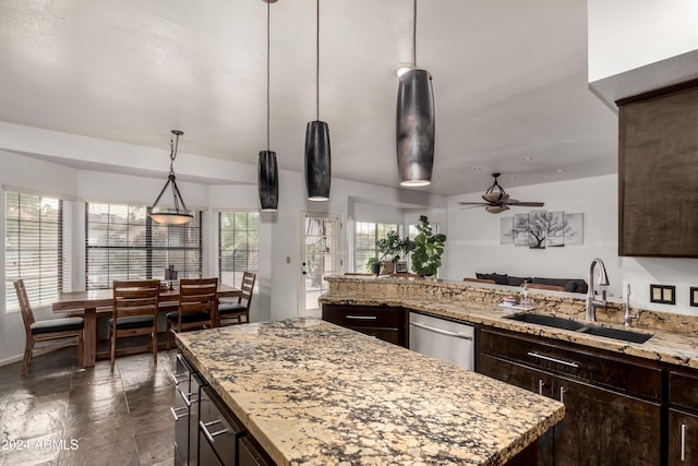 kitchen featuring dark brown cabinetry, stainless steel dishwasher, ceiling fan, and sink