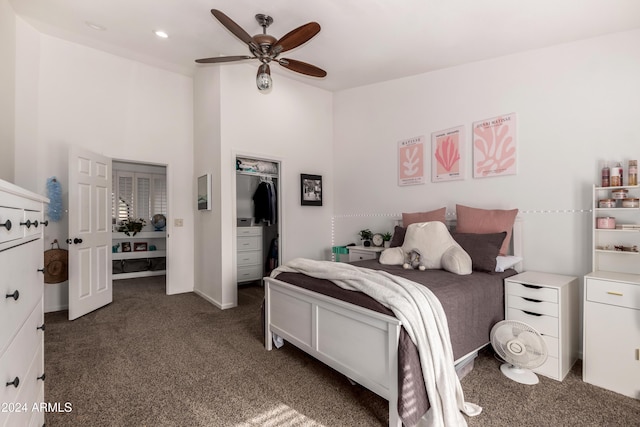 carpeted bedroom with ceiling fan, a spacious closet, and a closet