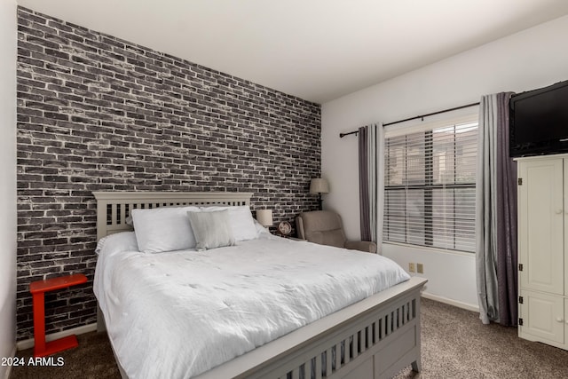 carpeted bedroom with brick wall