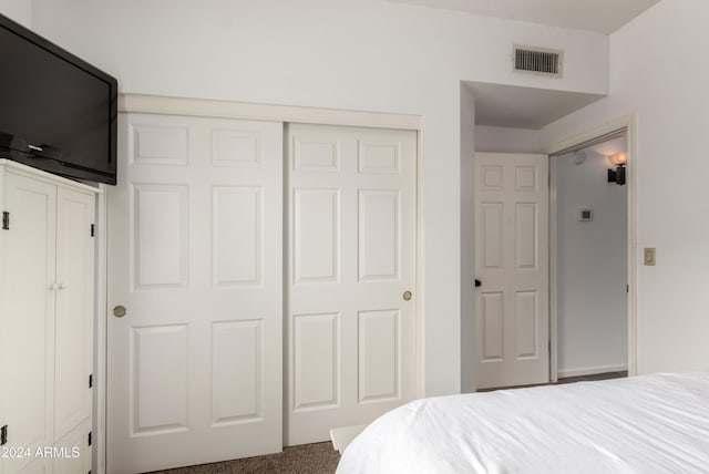 carpeted bedroom with a closet