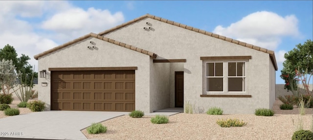 view of front of house with driveway, an attached garage, a tile roof, and stucco siding