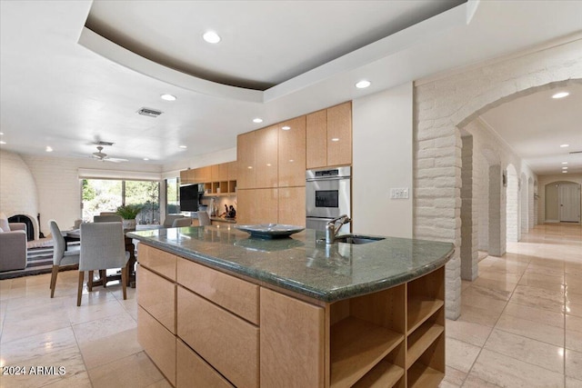 6516 E Maverick Rd, Paradise Valley, AZ 85253 - kitchen with modern cabinets, dark stone counters, arched walkways, a sink, and a tray ceiling