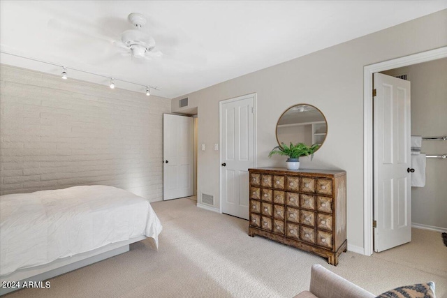 6516 E Maverick Rd, Paradise Valley, AZ 85253 - carpeted bedroom featuring baseboards, visible vents, track lighting, and brick wall
