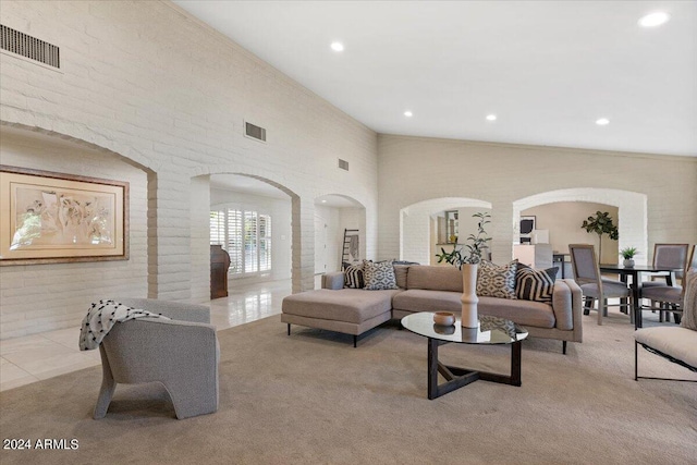 6516 E Maverick Rd, Paradise Valley, AZ 85253 - carpeted living room with tile patterned floors, visible vents, a high ceiling, and arched walkways