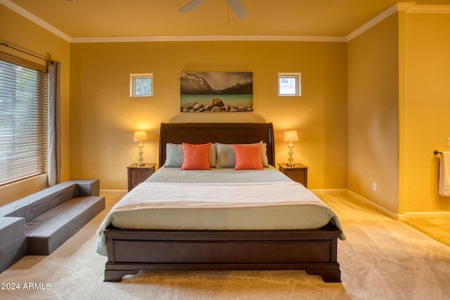 carpeted bedroom featuring a ceiling fan, multiple windows, crown molding, and baseboards