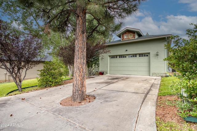 garage featuring concrete driveway