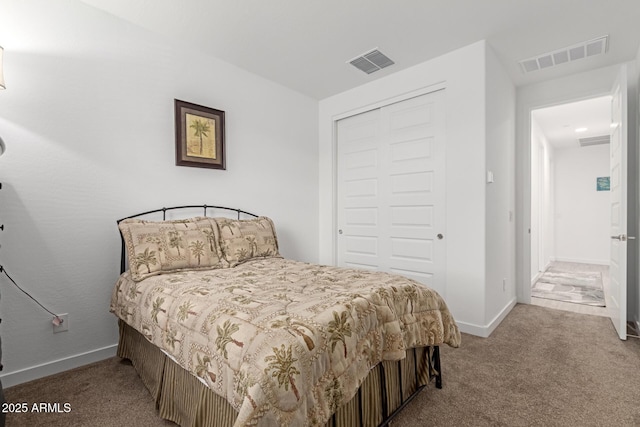 bedroom featuring a closet, visible vents, and carpet