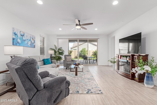 living room with recessed lighting, wood finished floors, and ceiling fan