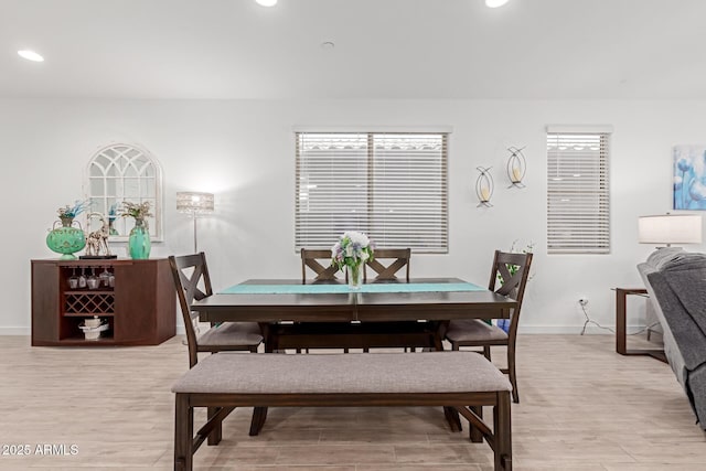 dining area featuring light wood finished floors, recessed lighting, and baseboards