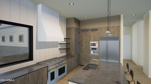 kitchen with sink, light hardwood / wood-style flooring, built in appliances, custom range hood, and decorative light fixtures