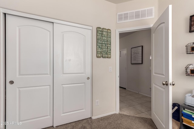 bedroom featuring light tile patterned floors and a closet