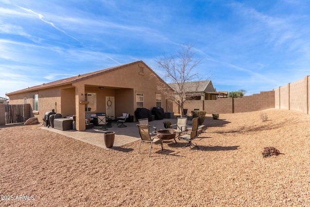 back of house with a patio area and an outdoor fire pit