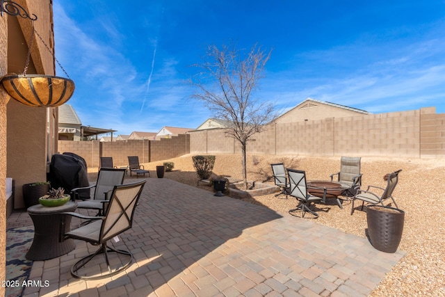 view of patio featuring area for grilling and a fire pit