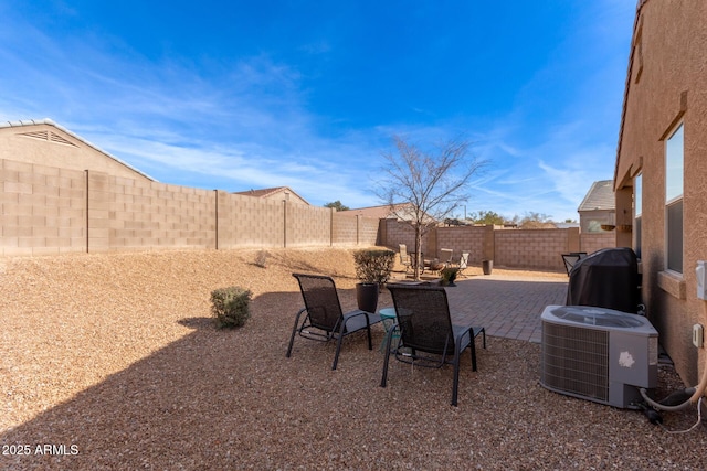 view of yard featuring central AC and a patio