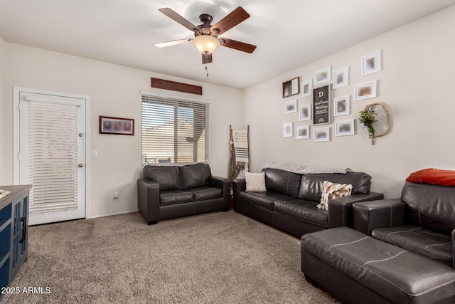 carpeted living room with ceiling fan