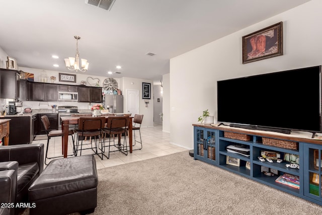 carpeted living room featuring a notable chandelier