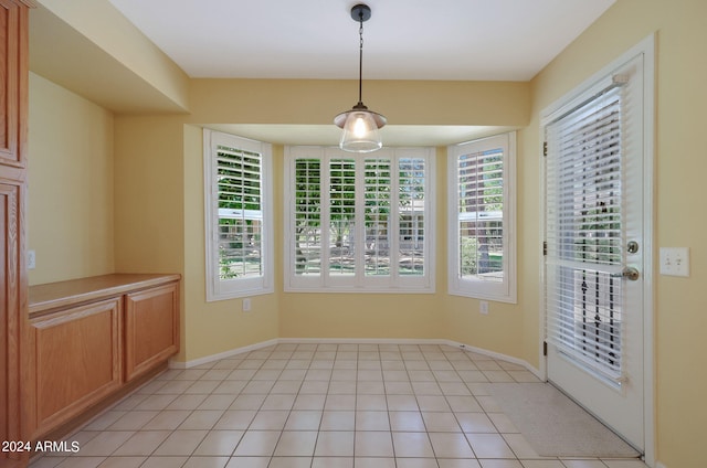 unfurnished dining area with light tile patterned flooring