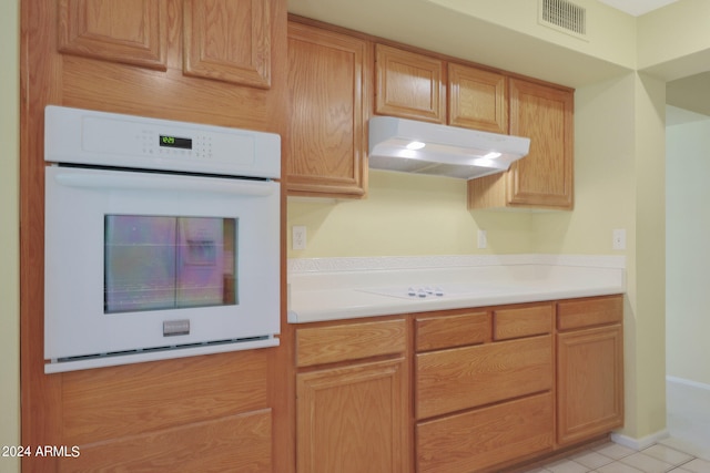 kitchen with oven and light tile patterned flooring