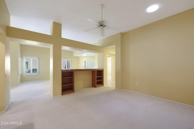 interior space with ceiling fan and light carpet